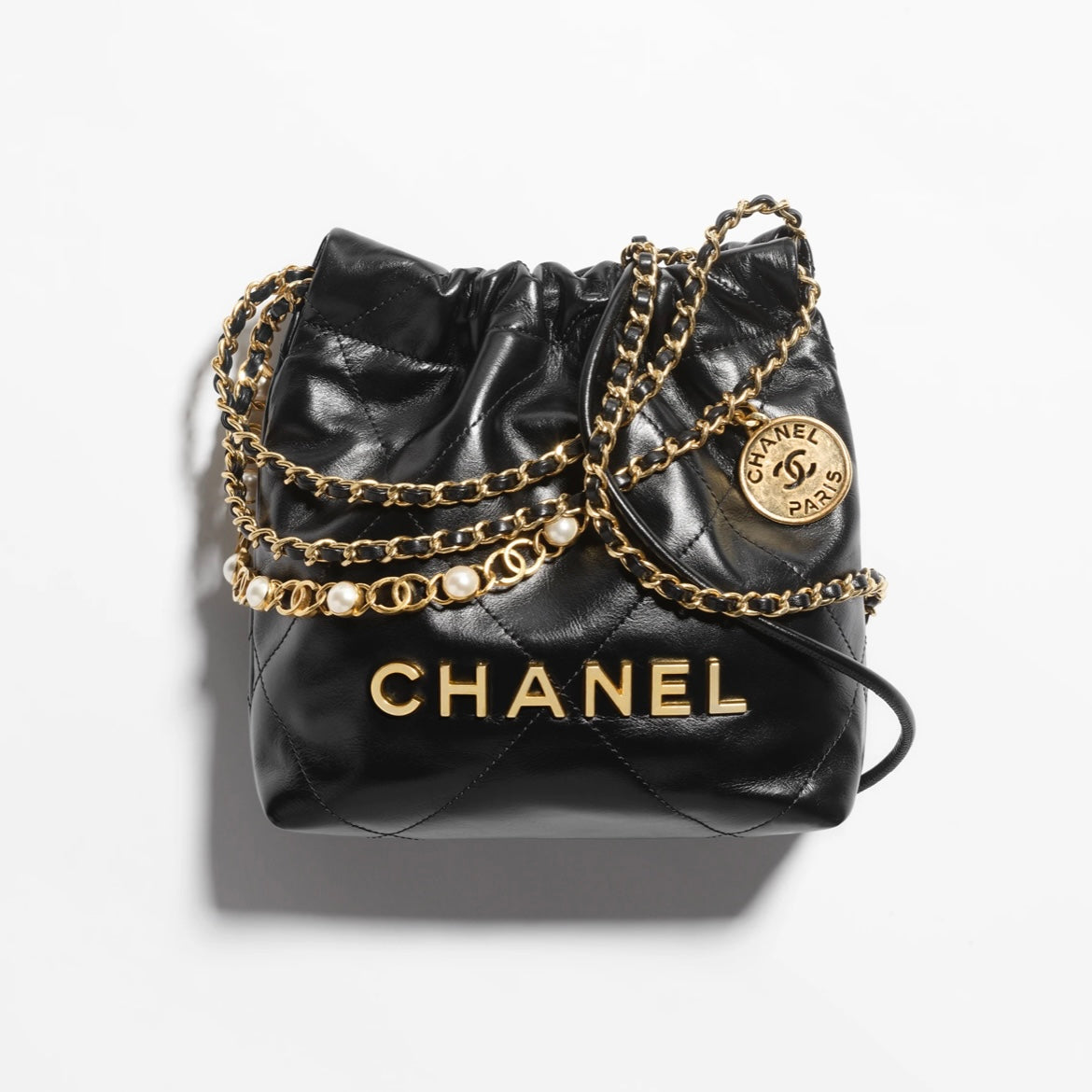 CHANEL 22 Pearl Handbag，黑色亮面小牛皮，珍珠鏈條與雙用背法設計，完美平衡時尚與功能。